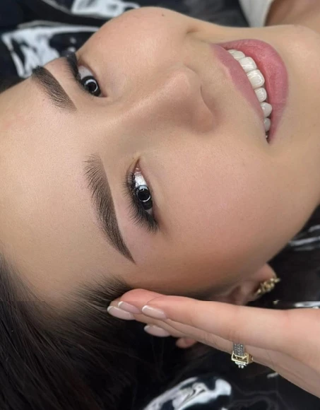 Close-up of defined brows and soft lip color from Permanent Makeup NYC